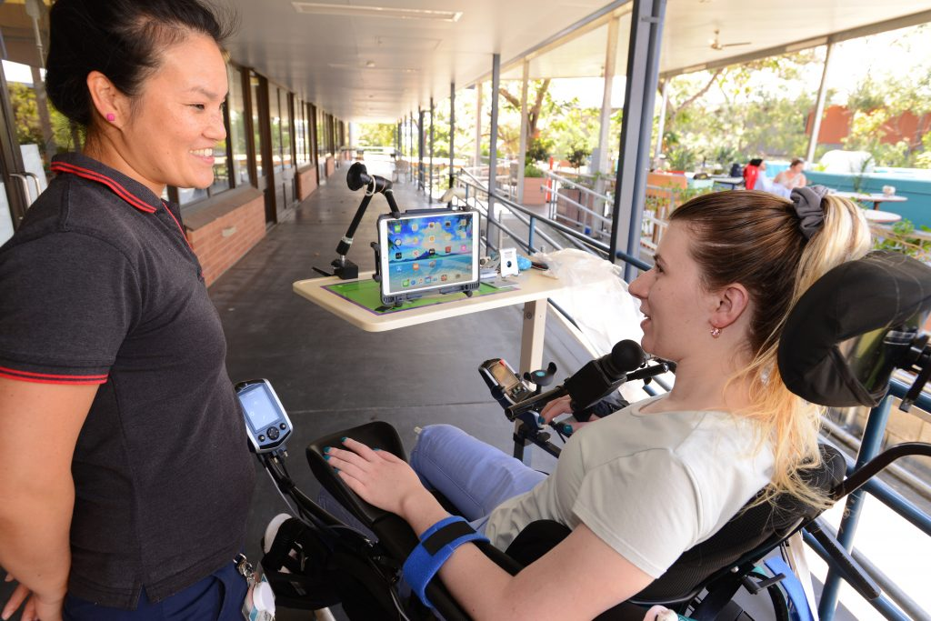 Woman in wheelchair using assitive technology screen