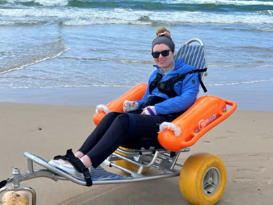 Girl in beach wheelchair